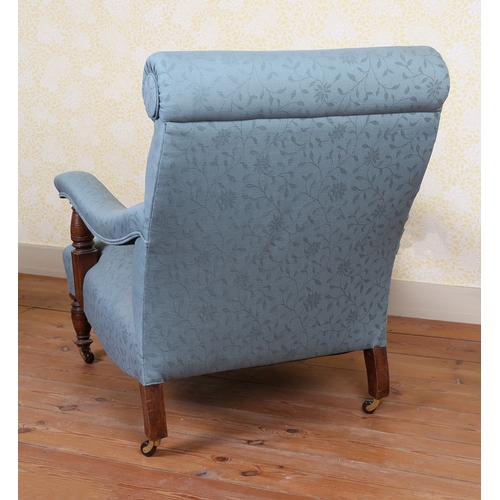 39 - A HOWARD AND SONS TYPE ARMCHAIR. having a scroll back above down swept arms upholstered in a blue fl... 