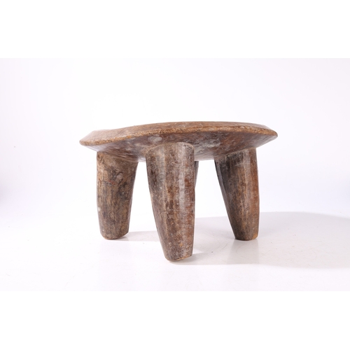 44 - A SENUFO STOOL, WEST AFRICA. the dished seat raised on four tapering legs, 36cm wide, 32.5cm deep, 2... 