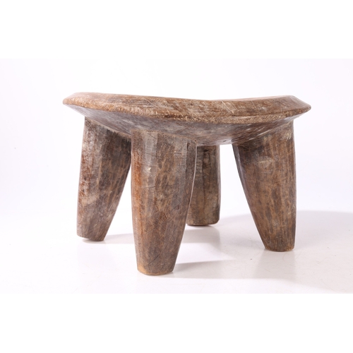 44 - A SENUFO STOOL, WEST AFRICA. the dished seat raised on four tapering legs, 36cm wide, 32.5cm deep, 2... 