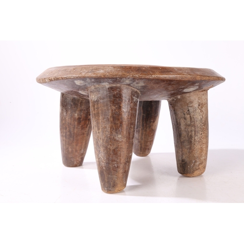 44 - A SENUFO STOOL, WEST AFRICA. the dished seat raised on four tapering legs, 36cm wide, 32.5cm deep, 2... 