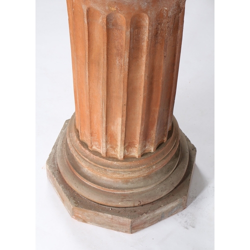 47 - A THOMAS & CO TERRACOTTA PEDESTAL. the circular top on a fluted central column, waisted foot and oct... 