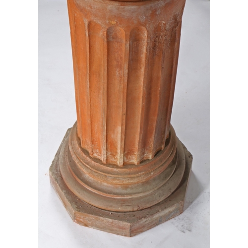 47 - A THOMAS & CO TERRACOTTA PEDESTAL. the circular top on a fluted central column, waisted foot and oct... 