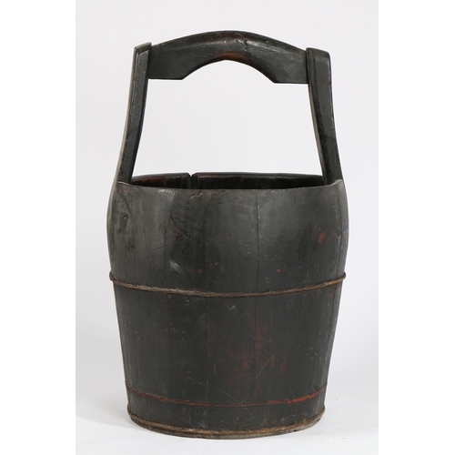 66 - A CHINESE ELM WELL BUCKET. with carrying handle above a coopered tapering lower section, 41cm diamet... 