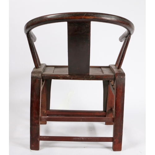 67 - A CHINESE QING DYNASTY HORSESHOE CHAIR. the splat back with carved roundel flanked by two arm suppor... 