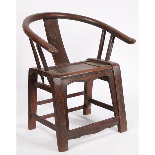 67 - A CHINESE QING DYNASTY HORSESHOE CHAIR. the splat back with carved roundel flanked by two arm suppor... 