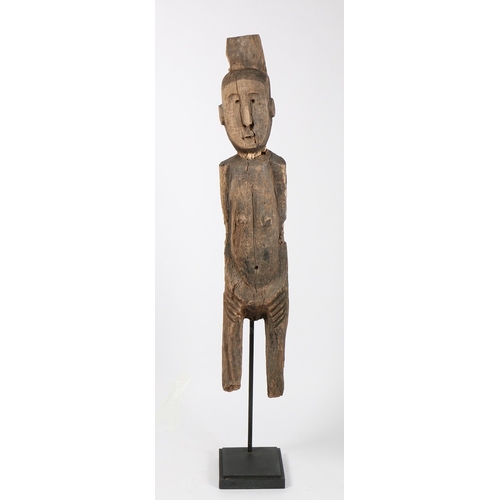 71 - A PRIMITIVE WOODEN CARVED FIGURE. Possibly Laos/ North-East Thailand, with crudely carved head and b... 