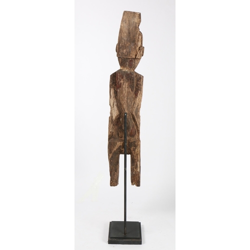 71 - A PRIMITIVE WOODEN CARVED FIGURE. Possibly Laos/ North-East Thailand, with crudely carved head and b... 