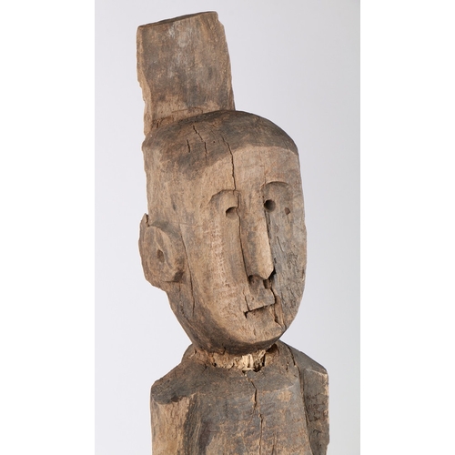 71 - A PRIMITIVE WOODEN CARVED FIGURE. Possibly Laos/ North-East Thailand, with crudely carved head and b... 