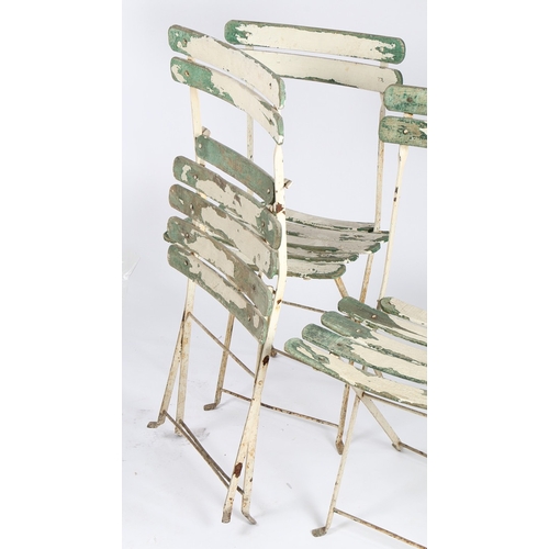 74 - FOUR FRENCH FOLDING PATIO CHAIRS. With painted slatted backs and seats, 45.5cm wide.