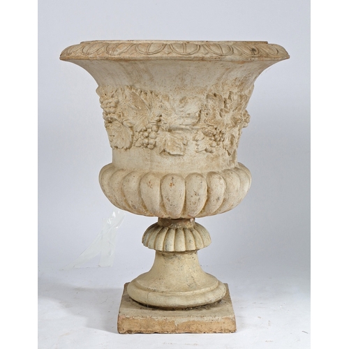 87 - A RECONSTITUTED STONE GARDEN URN. the fruiting vine decorated central band above a gadrooned lower s... 