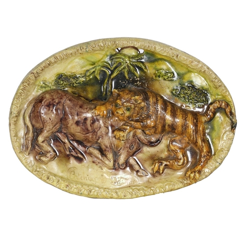 94 - A 19TH CENTURY STAFFORDSHIRE OVAL PLAQUE. depicting a tiger attacking an antelope, captioned 