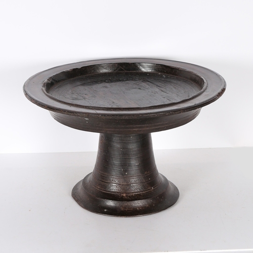 96 - A SUBSTANTIAL AFRICAN PEDESTAL BOWL. possibly Nigerian, the shallow dished circular top, raised on a... 