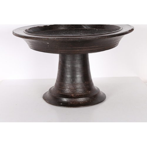 96 - A SUBSTANTIAL AFRICAN PEDESTAL BOWL. possibly Nigerian, the shallow dished circular top, raised on a... 