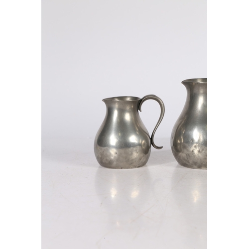 127 - A SET OF THREE GEORGE III PEWTER PRE-IMPERIAL JUGS, CIRCA 1780. Each having a pear-shaped body, with... 