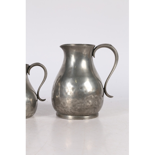 127 - A SET OF THREE GEORGE III PEWTER PRE-IMPERIAL JUGS, CIRCA 1780. Each having a pear-shaped body, with... 