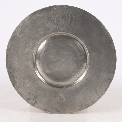 128 - A LATE 17TH CENTURY PEWTER BROAD RIM PLATE, SWISS. The rim with engraved mantled crest, opposed by t... 