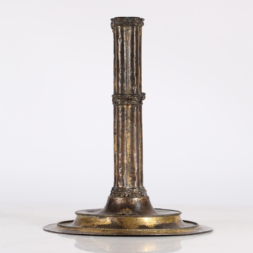 183 - A RARE GILT-COPPER CANDLESTICK, FRENCH, CIRCA 1500. The cluster-column stem with applied foliate ban... 