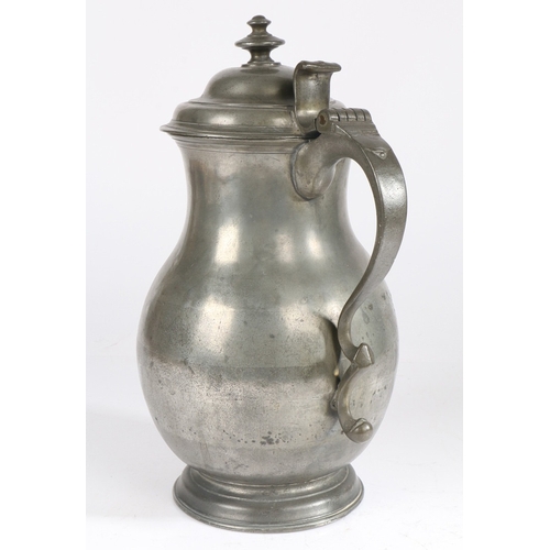 24 - A MID-18TH CENTURY PEWTER BALUSTER-SHAPED LAVER/FLAGON, CIRCA 1750. Having a domed lid with two-tier... 