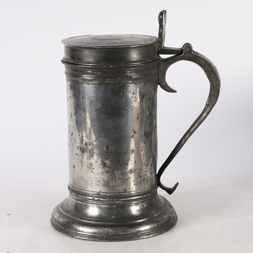 33 - A LARGE CHARLES II PEWTER BEEFEATER FLAGON, CIRCA 1680. With wide plain drum, ovolo-moulded footrim ... 