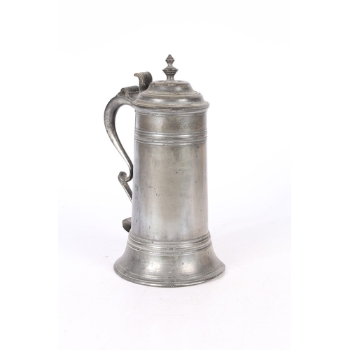 49 - A GEORGE II PEWTER SPIRE FLAGON, CIRCA 1720-50. The tapering drum with high fillet and flared skirt ... 