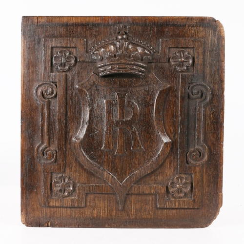 517 - AN EARLY 17TH CENTURY CARVED OAK PANEL. Centred by a large shield carved with the entwined initials ... 