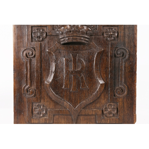 517 - AN EARLY 17TH CENTURY CARVED OAK PANEL. Centred by a large shield carved with the entwined initials ... 