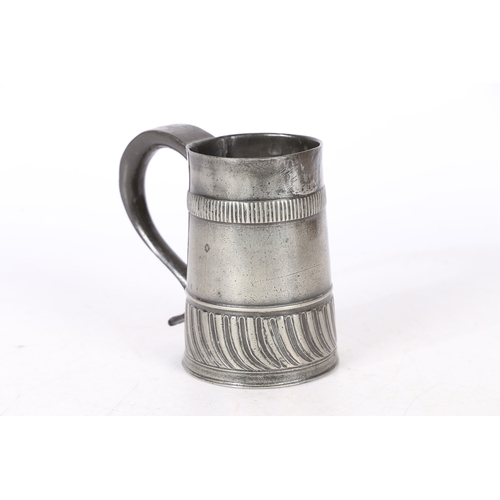 55 - A RARE WILLIAM & MARY PEWTER GADROONED PINT MUG, CIRCA 1700-02. The tapering straight-sided body wit... 