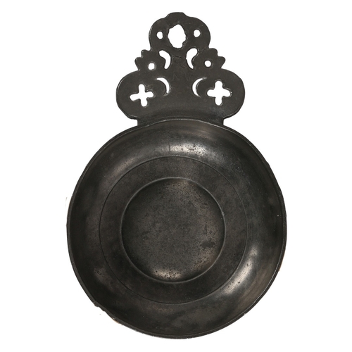 58 - A WILLIAM & MARY PEWTER PORRINGER, CIRCA 1690. Having a geometric-pierced cartouche ear, stamped wit... 