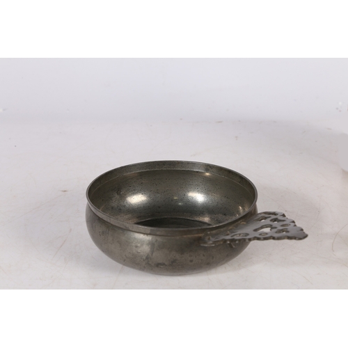 59 - A WILLIAM & MARY PEWTER PORRINGER, CIRCA 1690. Having a geometric-pierced cartouche ear bellied bowl... 