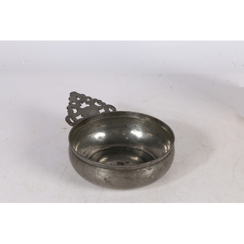 59 - A WILLIAM & MARY PEWTER PORRINGER, CIRCA 1690. Having a geometric-pierced cartouche ear bellied bowl... 