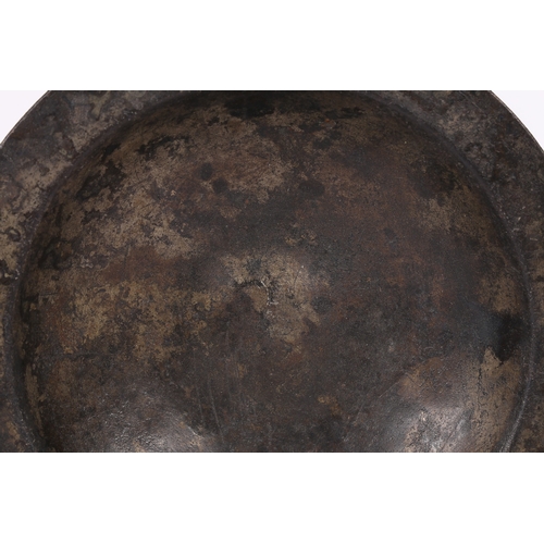 60 - A 16TH CENTURY PEWTER BUMPY-BOTTOM DISH, CIRCA 1500. The narrow flat rim with crowned hammer mark, a... 