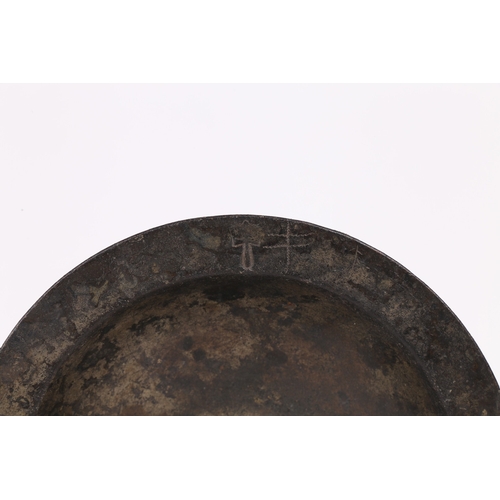 60 - A 16TH CENTURY PEWTER BUMPY-BOTTOM DISH, CIRCA 1500. The narrow flat rim with crowned hammer mark, a... 