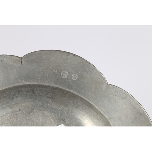 61 - A RARE SHAPED GEORGE II PEWTER DISH, CIRCA 1750. The eight-lobed rim with applied double-reeded edge... 