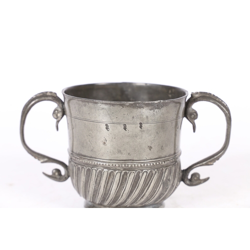 62 - A RARE AND FINE QUEEN ANNE PEWTER TWIN-HANDLED GADROONED CUP, WIGAN, CIRCA 1705. The cup with plain ... 