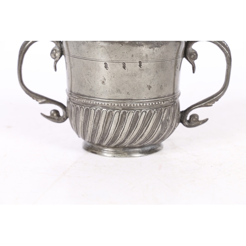 62 - A RARE AND FINE QUEEN ANNE PEWTER TWIN-HANDLED GADROONED CUP, WIGAN, CIRCA 1705. The cup with plain ... 