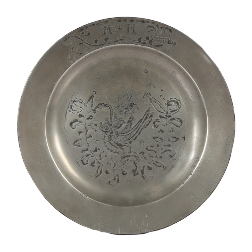 63 - A GEORGE III PEWTER ENGRAVED PLAIN RIM PLATE, CIRCA 1780. The well designed with an enchained swan d... 