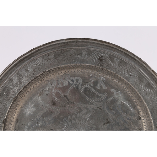 64 - A RARE PEWTER WRIGGLEWORK PLATE, ENGLISH, CIRCA 1700-10. The well designed with three flowering stem... 