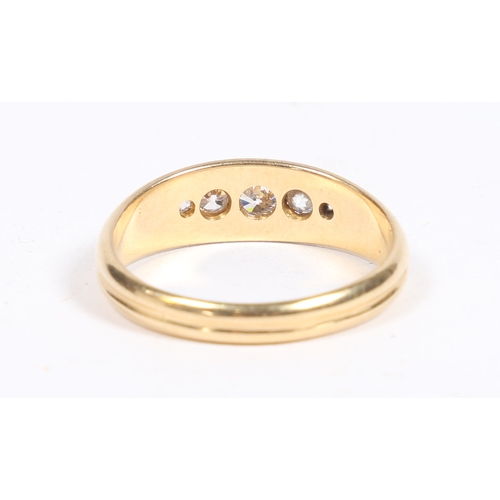 11 - AN 18 CARAT GOLD AND DIAMOND RING. the oval reeded head set with five graduated diamonds, ring size ... 