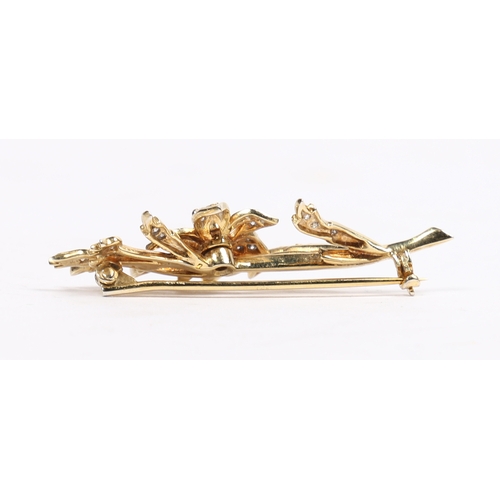 16 - AN 18 CARAT GOLD AND DIAMOND BROOCH. in the form of a flowering branch, the central diamond measurin... 