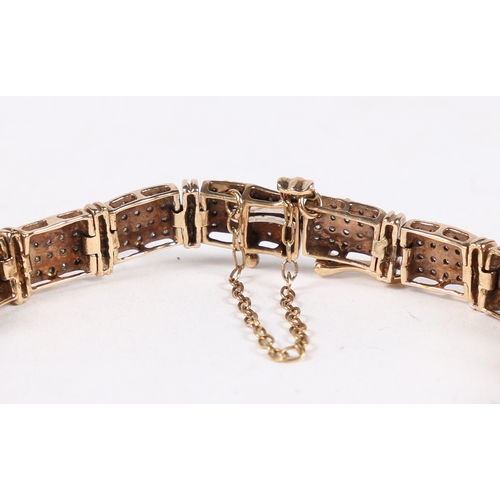 17 - A 9 CARAT GOLD AND DIAMOND BRACELET. formed from nineteen rectangular panels each set with twenty ro... 