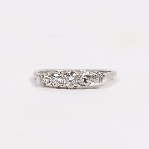 18 - A PLATINUM AND DIAMOND RING. the head set with five graduated circular diamonds, approximately 0.40c... 