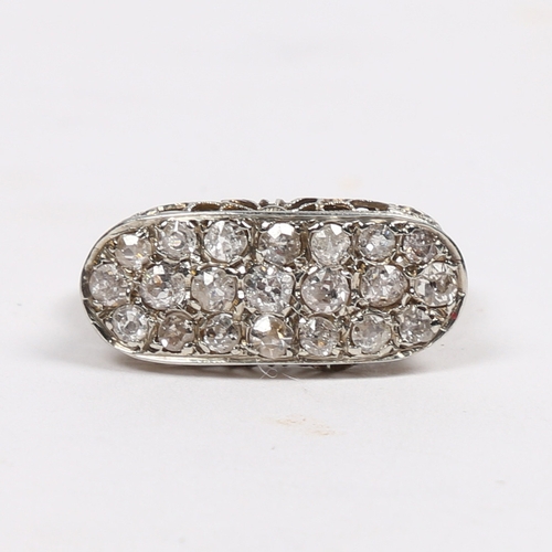 20 - AN 18 CARAT WHITE GOLD AND DIAMOND RING. the oval head set with 21 round cut diamonds and with pierc... 