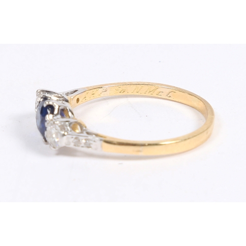 27 - A YELLOW METAL, SAPPHIRE AND DIAMOND RING. the head with a central sapphire flanked by two diamonds ... 