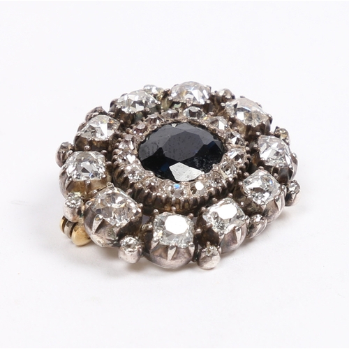 29 - AN EARLY 19TH CENTURY SAPPHIRE AND DIAMOND BROOCH. the central oval facet cut sapphire surrounded by... 