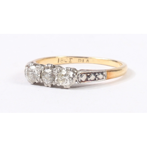 3 - AN 18 CARAT GOLD, PLATINUM AND DIAMOND RING. the head set with three round cut diamonds, flanked by ... 