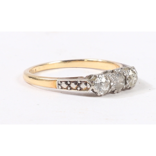 3 - AN 18 CARAT GOLD, PLATINUM AND DIAMOND RING. the head set with three round cut diamonds, flanked by ... 