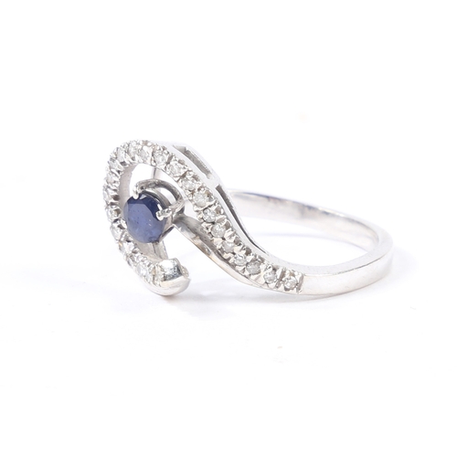 30 - AN 18 CARAT GOLD, SAPPHIRE AND DIAMOND RING. the pierced scrolling diamond set head with central rou... 