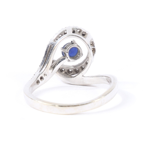 30 - AN 18 CARAT GOLD, SAPPHIRE AND DIAMOND RING. the pierced scrolling diamond set head with central rou... 