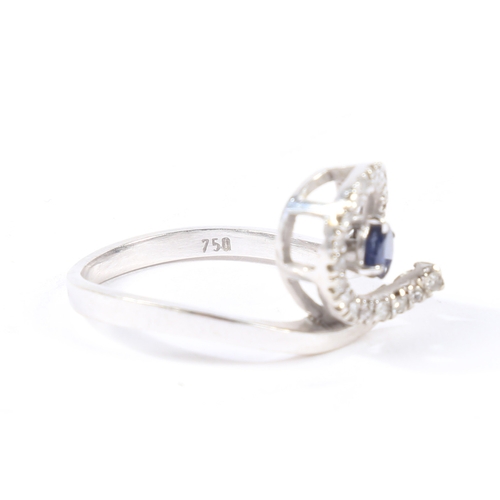 30 - AN 18 CARAT GOLD, SAPPHIRE AND DIAMOND RING. the pierced scrolling diamond set head with central rou... 