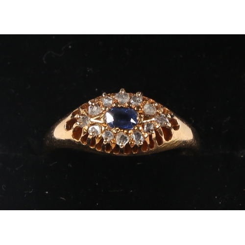 31 - AN 18 CARAT GOLD SAPPHIRE AND DIAMOND RING. the central rectangular facet cut sapphire surrounded by... 